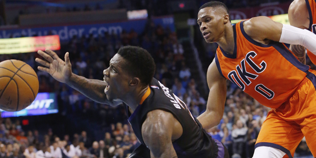 Phoenix Suns guard Eric Bledsoe (2) looses the ball as he fouled by Oklahoma City Thunder guard Rus...