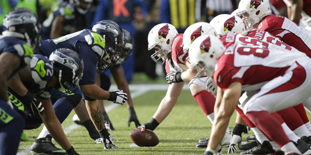 Arizona Cardinals and Seattle Seahawks players line up on the line of scrimmage in the first half o...