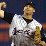 The Diamondbacks switched up their road gray jerseys in 2001, going with the sleeveless/undershirt look that was popular at the time.  (AP Photo/Lenny Ignelzi)