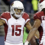 Arizona Cardinals wide receiver Michael Floyd (15) is greeted by wide receiver Larry Fitzgerald (11) after Floyd scored a touchdown during the first half of an NFL football game against the Seattle Seahawks, Sunday, Nov. 15, 2015, in Seattle. (AP Photo/Stephen Brashear)