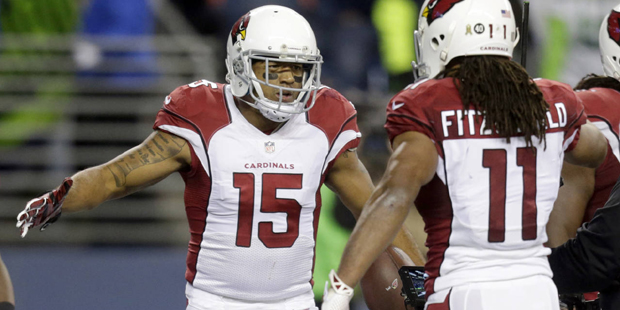 Arizona Cardinals wide receiver Michael Floyd (15) is greeted by wide receiver Larry Fitzgerald (11...