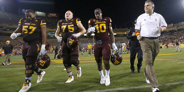 FILE - In this Sept. 26, 2015 file photo, Arizona State head coach Todd Graham, right, runs off the...