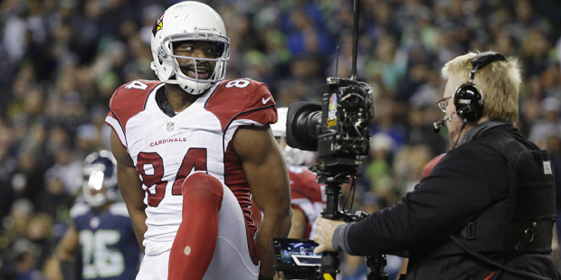 Arizona Cardinals tight end Jermaine Gresham holds the football behind his back as a television cam...