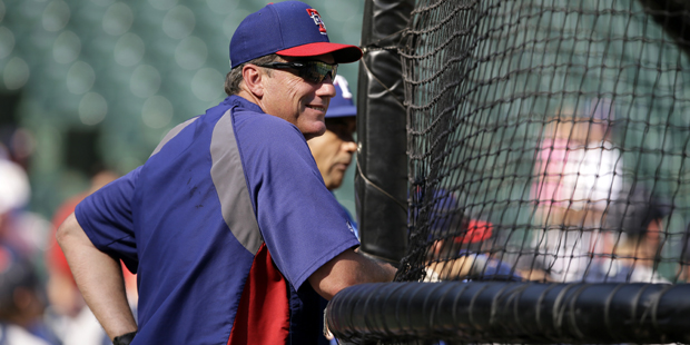 Texas Rangers batting coach Dave Magadan watches members of the team take batting practice before a...