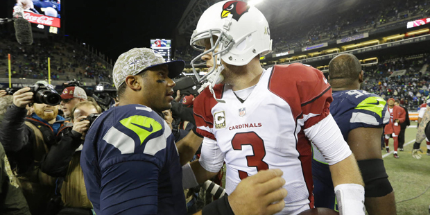 Seattle Seahawks quarterback Russell Wilson, left, greets Arizona Cardinals quarterback Carson Palm...