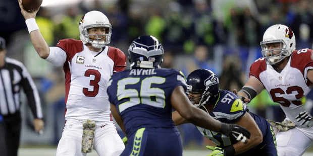 Arizona Cardinals quarterback Carson Palmer (3) passes under pressure from Seattle Seahawks defensi...