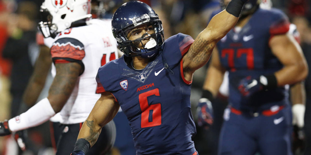 Arizona wide receiver Nate Phillips reacts after scoring a touchdown in double overtime against Uta...