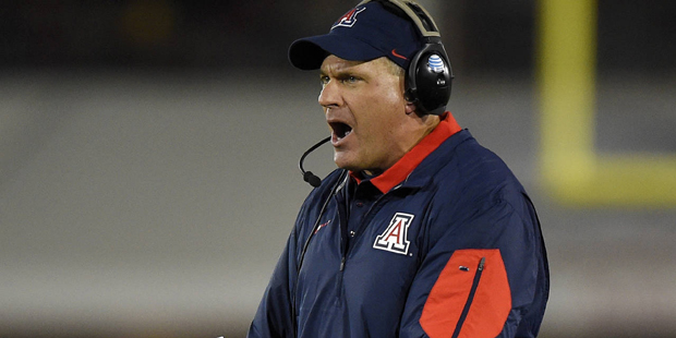 Arizona coach Rich Rodriguez yells to his team during the first half of an NCAA college football ga...