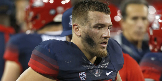 Arizona linebacker Scooby Wright III limps off the field during the first half of an NCAA college f...