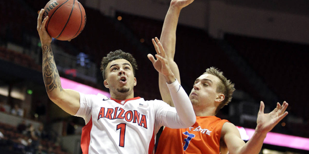 Arizona guard Gabe York, left, drives to the basket under pressure by Boise State guard Anthony Drm...