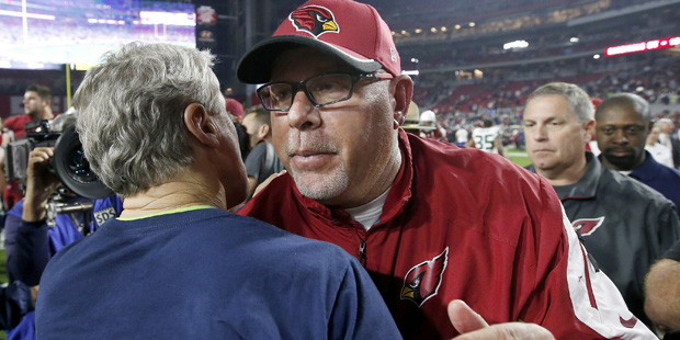 Arizona Cardinals head coach Bruce Arians, right, talks with Seattle Seahawks head coach Pete Carro...