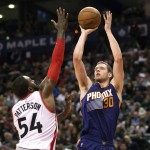 Phoenix Suns' Jon Leuer, right, shoots over Toronto Raptors' Patrick Patterson during the second half of an NBA basketball game in Toronto on Sunday, Nov. 29, 2015. (Darren Calabrese/The Canadian Press via AP) MANDATORY CREDIT
