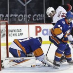 Arizona Coyotes' Martin Hanzal (11) is defended by New York Islanders goalie Jaroslav Halak, (41) and Calvin de Haan (44) during the third period of an NHL hockey game Monday, Nov. 16, 2015, in New York. Hazal scored on the play. The Islanders won the game 5-2. (AP Photo/Frank Franklin II)