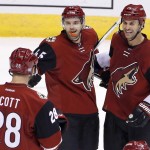 Arizona Coyotes' Stefan Elliott (45) celebrates his goal against the Edmonton Oilers with teammates John Scott (28) and Kyle Chipchura (24) during the second period of an NHL hockey game Thursday, Nov. 12, 2015, in Glendale, Ariz. (AP Photo/Ross D. Franklin)