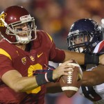 Southern California quarterback Cody Kessler, left, tries to hold off Arizona defensive lineman Reggie Gilbert during the first half of an NCAA college football game, Saturday, Nov. 7, 2015, in Los Angeles. (AP Photo/Mark J. Terrill)