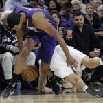 Phoenix Suns' T.J. Warren, left, and San Antonio Spurs' Manu Ginobili, right, scramble for a loose ball during the first half of an NBA basketball game, Monday, Nov. 23, 2015, in San Antonio. (AP Photo/Eric Gay)