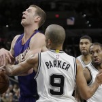 Phoenix Suns' Jon Leuer, left, is fouled by San Antonio Spurs' Tony Parker (9) during the first half of an NBA basketball game, Monday, Nov. 23, 2015, in San Antonio. (AP Photo/Eric Gay)