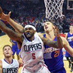 Los Angeles Clippers forward Josh Smith, center, grabs a rebound away from Phoenix Suns center Alex Len, right, of Ukraine, as forward Blake Griffin, lower left, watches during the first half of an NBA basketball game, Monday, Nov. 2, 2015, in Los Angeles. (AP Photo/Mark J. Terrill)