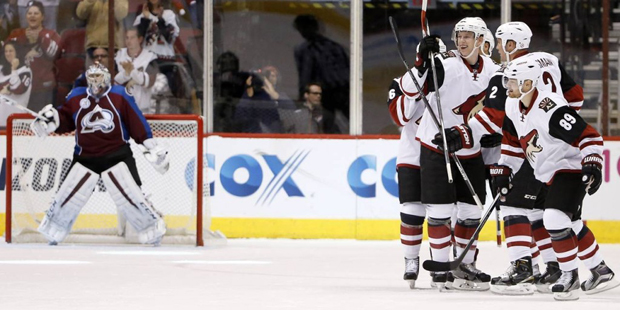 Arizona Coyotes' Nicklas Grossmann (2), of Sweden, celebrates with teammates, including Connor Murp...