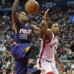 Phoenix Suns' Eric Bledsoe, left, is fouled by Toronto Raptors' Kyle Lowry during the second half of an NBA basketball game in Toronto on Sunday, Nov. 29, 2015. (Darren Calabrese/The Canadian Press via AP) MANDATORY CREDIT