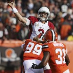 Arizona Cardinals quarterback Carson Palmer (3) passes under pressure from Cleveland Browns linebacker Paul Kruger (99) in the first half of an NFL football game, Sunday, Nov. 1, 2015, in Cleveland. (AP Photo/Ron Schwane)