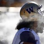 Washington's Vita Vea gets hit with moisture from a misting machines on the sidelines during the first half of an NCAA college football game against Arizona State Saturday, Nov. 14, 2015, in Tempe, Ariz. (AP Photo/Ross D. Franklin)