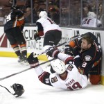 Arizona Coyotes' Shane Doan, bottom, and Anaheim Ducks' Clayton Stoner fall to the ice as they fight for the puck during the first period of an NHL hockey game, Monday, Nov. 9, 2015, in Anaheim, Calif. (AP Photo/Jae C. Hong)