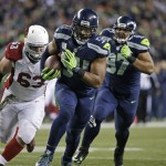 Seattle Seahawks middle linebacker Bobby Wagner (54) returns an Arizona Cardinals fumble for a touchdown as Cardinals' Lyle Sendlein (63) pursues during the second half of an NFL football game, Sunday, Nov. 15, 2015, in Seattle. (AP Photo/Elaine Thompson)
