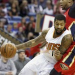 Phoenix Suns forward Markieff Morris (11) makes a drive against New Orleans Pelicans forward Anthony Davis in the first half of an NBA basketball game in New Orleans, Sunday, Nov. 22, 2015. (AP Photo/Max Becherer)
