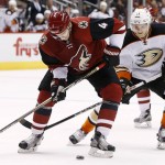 Arizona Coyotes' Zbynek Michalek (4), of the Czech Republic, tries to control the puck in front of Anaheim Ducks' Jakob Silfverberg (33), of Sweden, during the first period of an NHL hockey game Wednesday, Nov. 25, 2015, in Glendale, Ariz. (AP Photo/Ross D. Franklin)