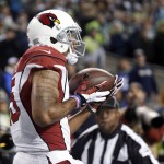 Arizona Cardinals wide receiver Michael Floyd catches a pass for a touchdown against the Seattle Seahawks during the first half of an NFL football game, Sunday, Nov. 15, 2015, in Seattle. (AP Photo/Elaine Thompson)