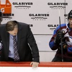 Colorado Avalanche head coach Patrick Roy, senter, slumps at the team bench after a goal by Arizona Coyotes' Steve Downie was allowed, as Avalanche's Alex Tanguay, right, and Carl Soderberg, left, of Sweden, flank him during the second period of an NHL hockey game Thursday, Nov. 5, 2015, in Glendale, Ariz. (AP Photo/Ross D. Franklin)