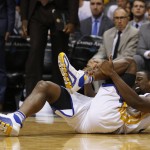 Golden State Warriors forward Harrison Barnes reacts after in injury during the third quarter during an NBA basketball game against the Phoenix Suns, Friday, Nov. 27, 2015, in Phoenix. (AP Photo/Rick Scuteri)