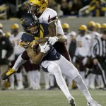 California wide receiver Bryce Treggs, left, is tackled by Arizona State defensive back Kareem Orr during the first half of an NCAA college football game in Berkeley, Calif., Saturday, Nov. 28, 2015. (AP Photo/Jeff Chiu)