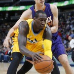 Denver Nuggets forward J.J. Hickson, front, pulls in a loose ball in front of Phoenix Suns center Alex Len, of the Ukraine, in the first half of an NBA basketball game Friday, Nov. 20, 2015, in Denver. (AP Photo/David Zalubowski)