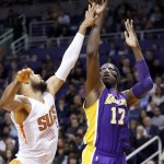 Los Angeles Lakers' Roy Hibbert (17) shoots over Phoenix Suns' Tyson Chandler, left, during the first half of an NBA basketball game Monday, Nov. 16, 2015, in Phoenix. (AP Photo/Ross D. Franklin)