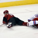 Arizona Coyotes' Tobias Rieder, left, of Germany, gets tripped up by New York Rangers' Ryan McDonagh, right, during the third period of an NHL hockey game Saturday, Nov. 7, 2015, in Glendale, Ariz. The Rangers defeated the Coyotes 4-1. (AP Photo/Ross D. Franklin)