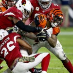 Cincinnati Bengals running back Jeremy Hill (32) is tackled by Arizona Cardinals free safety Rashad Johnson (26) and  defensive end Calais Campbell (93) during the first half of an NFL  football game, Sunday, Nov. 22, 2015, in Glendale, Ariz. (AP Photo/Ross D. Franklin)