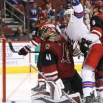 New York Rangers' J.T. Miller, second from right, celebrates his goal against Arizona Coyotes' Mike Smith (41) as Coyotes' Connor Murphy (5) defends during the second period of an NHL hockey game, Saturday, Nov. 7, 2015, in Glendale, Ariz. (AP Photo/Ross D. Franklin)
