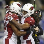 Arizona Cardinals' Larry Fitzgerald, right, hugs tight end Jermaine Gresham, left, after Gresham caught a pass for a touchdown against the Seattle Seahawks during the second half of an NFL football game, Sunday, Nov. 15, 2015, in Seattle. (AP Photo/Stephen Brashear)