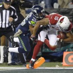 Arizona Cardinals wide receiver Michael Floyd comes down in bounds for a touchdown as Seattle Seahawks cornerback Cary Williams tries for the tackle during the first half of an NFL football game, Sunday, Nov. 15, 2015, in Seattle. (AP Photo/Elaine Thompson)