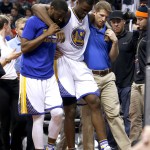 Golden State Warriors forward Harrison Barnes is helped off the court during the third quarter of an NBA basketball game against the Phoenix Suns, Friday, Nov. 27, 2015, in Phoenix. (AP Photo/Rick Scuteri)