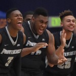 Members of Providence, from left, Kris Dunn, Quadree Smith and Drew Edwards celebrates from the bench during the first half of an NCAA college basketball game against Arizona at the Wooden Legacy tournament, Friday, Nov. 27, 2015, in Fullerton, Calif. (AP Photo/Mark J. Terrill)