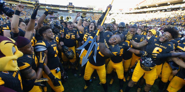 Arizona State's Antonio Longino, middle, gets ready to stab the pitchfork into the ground as he cel...