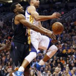 Golden State Warriors guard Stephen Curry, right, drives past Phoenix Suns guard Ronnie Price in the first quarter during an NBA basketball game, Friday, Nov. 27, 2015, in Phoenix. (AP Photo/Rick Scuteri)