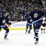 Winnipeg Jets' Dustin Byfuglien (33) celebrates his goal against the Arizona Coyotes during the second period of an NHL hockey game, in Winnipeg, Manitoba on Saturday, Nov. 21, 2015. (John Woods/The Canadian Press via AP) MANDATORY CREDIT