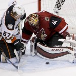 Arizona Coyotes' Mike Smith (41) makes a save on a shot by Anaheim Ducks' Rickard Rakell (67), of Sweden, as Coyotes' Antoine Vermette (50) defends during the second period of an NHL hockey game Wednesday, Nov. 25, 2015, in Glendale, Ariz. (AP Photo/Ross D. Franklin)