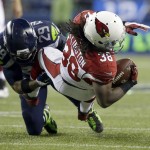 Seattle Seahawks free safety Earl Thomas tackles Arizona Cardinals running back Andre Ellington (38) during the second half of an NFL football game, Sunday, Nov. 15, 2015, in Seattle. (AP Photo/Elaine Thompson)