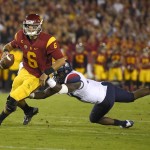 Southern California quarterback Cody Kessler, left, escapes the grasp of Arizona safety Paul Magloire Jr. during the first half of an NCAA college football game, Saturday, Nov. 7, 2015, in Los Angeles. (AP Photo/Mark J. Terrill)