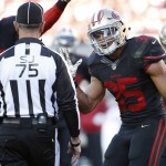 San Francisco 49ers safety Eric Reid (35) talks with side judge Rob Vernatchi (75) after being penalized for pass interference against the Arizona Cardinals during the second half of an NFL football game in Santa Clara, Calif., Sunday, Nov. 29, 2015. (AP Photo/Tony Avelar)